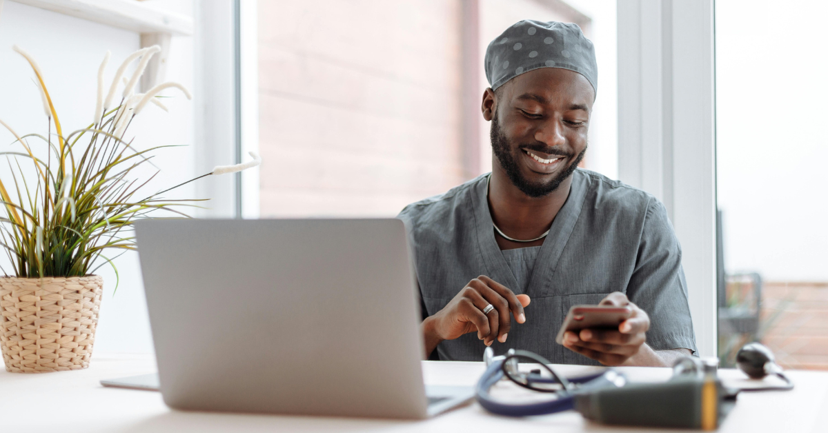 Doctor sitting at desk and on his phone